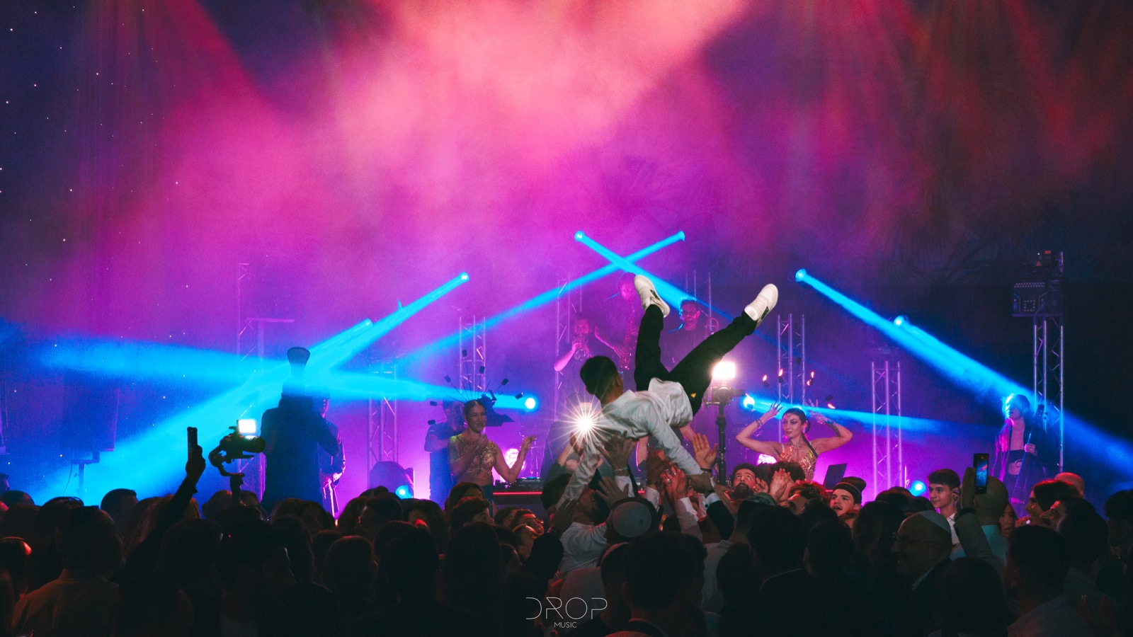 Lasers bleus et roses au-dessus de la foule, un invité porté à bout de bras, Drop Music